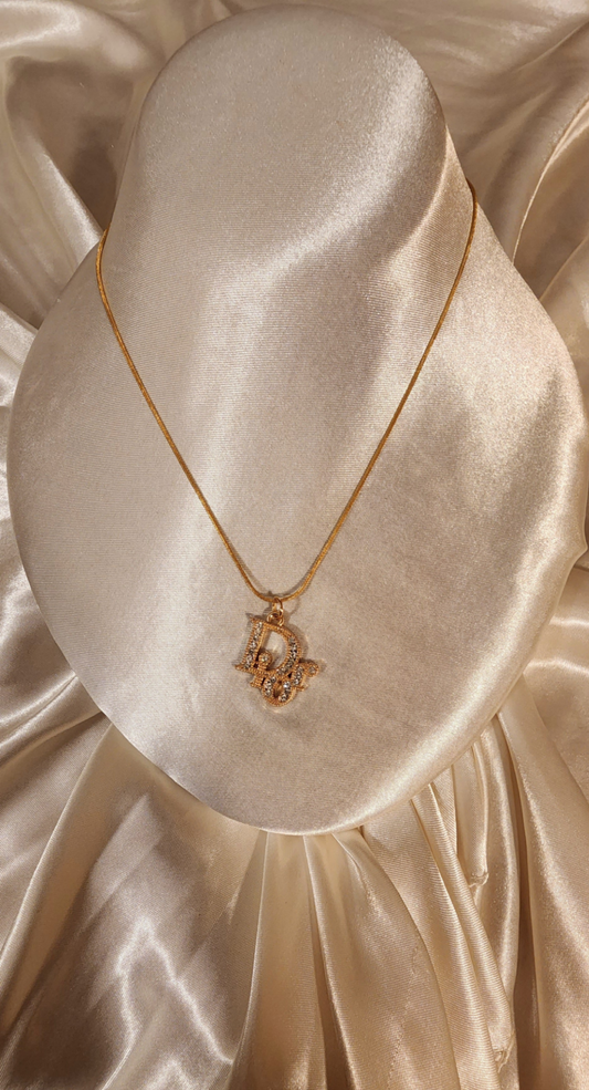 Repurposed vintage charm necklace from DR Era Collection with a crystal embedded pendant and a solid sterling silver chain plated in gold vermeil.
