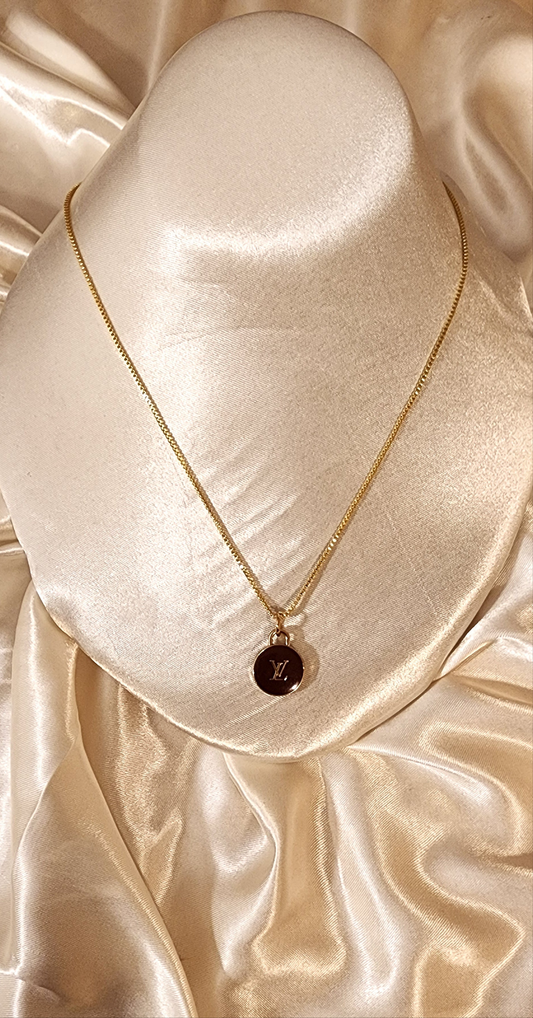 Repurposed vintage charm necklace from LV Era Collection with a brown charm pendant and a solid sterling silver chain plated in gold vermeil.