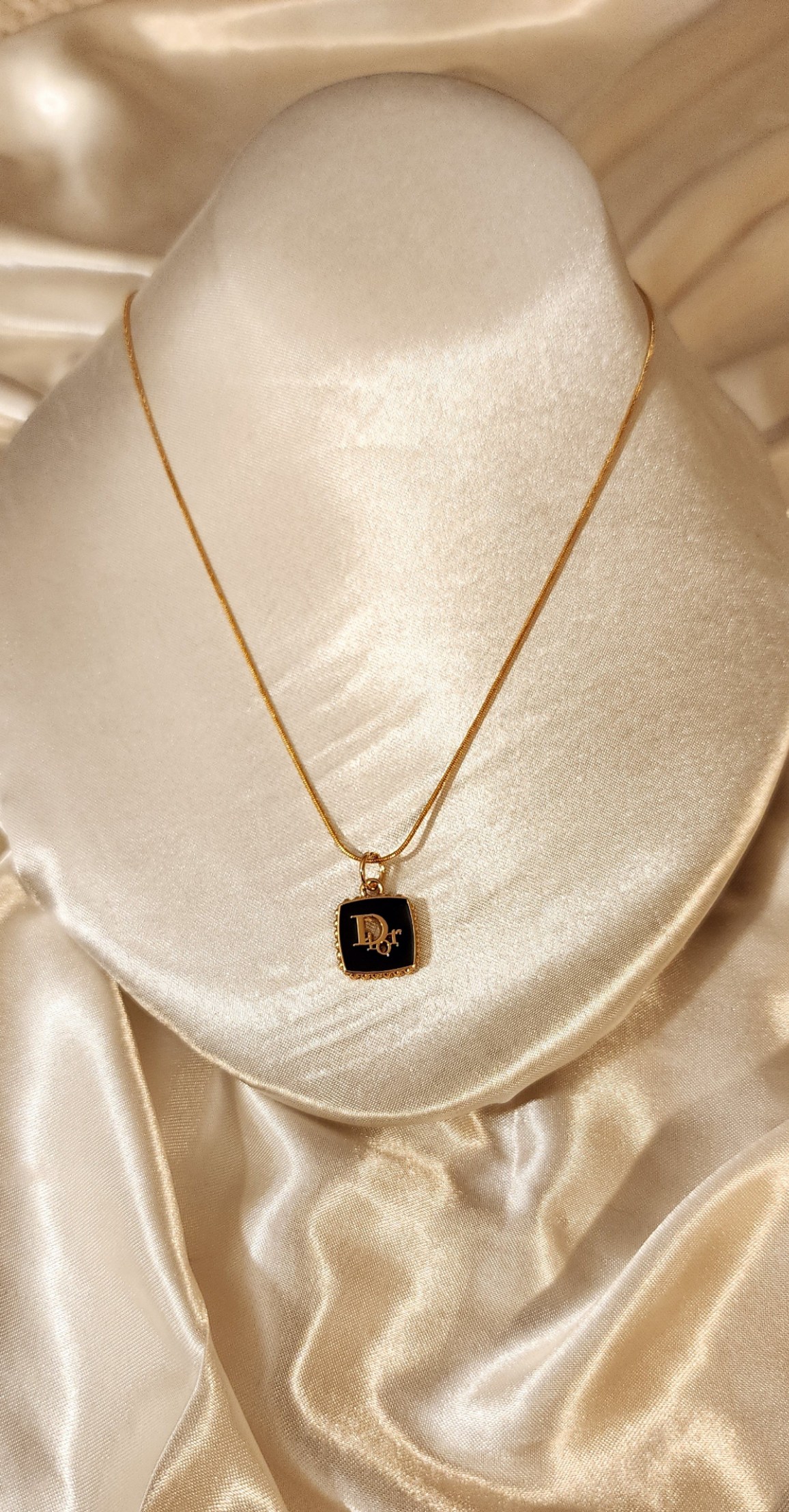 Repurposed vintage charm necklace from DR Era Collection with a delicate black and gold  pendant and a solid sterling silver chain plated in gold vermeil.