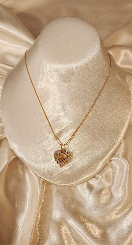 Repurposed vintage charm necklace from DR Era Collection with a crystal heart-shaped pendant and a solid sterling silver chain plated in gold vermeil.