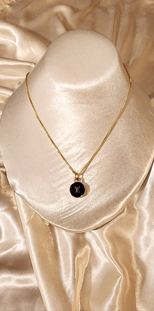 Repurposed vintage charm necklace from LV Era Collection with a black charm pendant and a solid sterling silver chain plated in gold vermeil.
