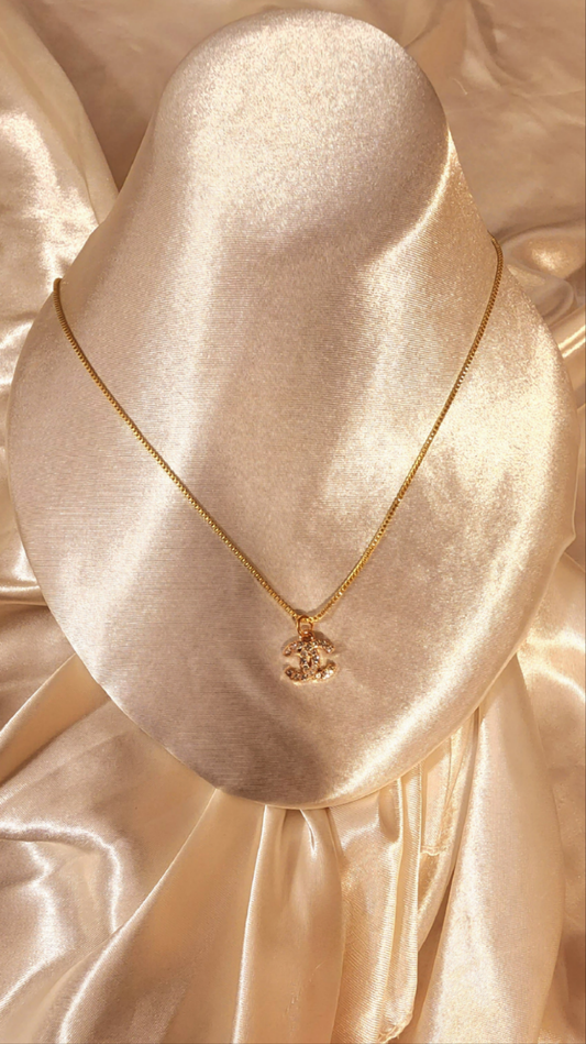 Repurposed vintage charm necklace from CC Era Collection with a crystal embedded pendant and a solid sterling silver chain plated in gold vermeil.