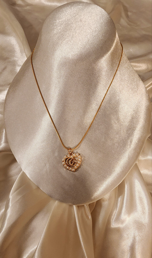 Repurposed vintage charm necklace from GG Era Collection a mini gold-tone pendant on a solid sterling silver chain plated in gold vermeil.