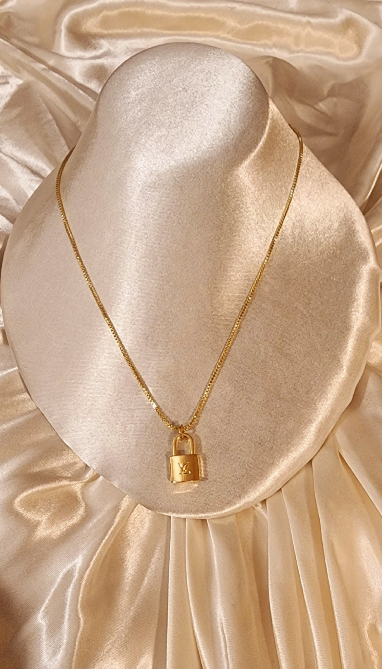 Repurposed vintage charm necklace from LV Era Collection with a gold-tone padlock pendant and a solid sterling silver chain plated in gold vermeil.