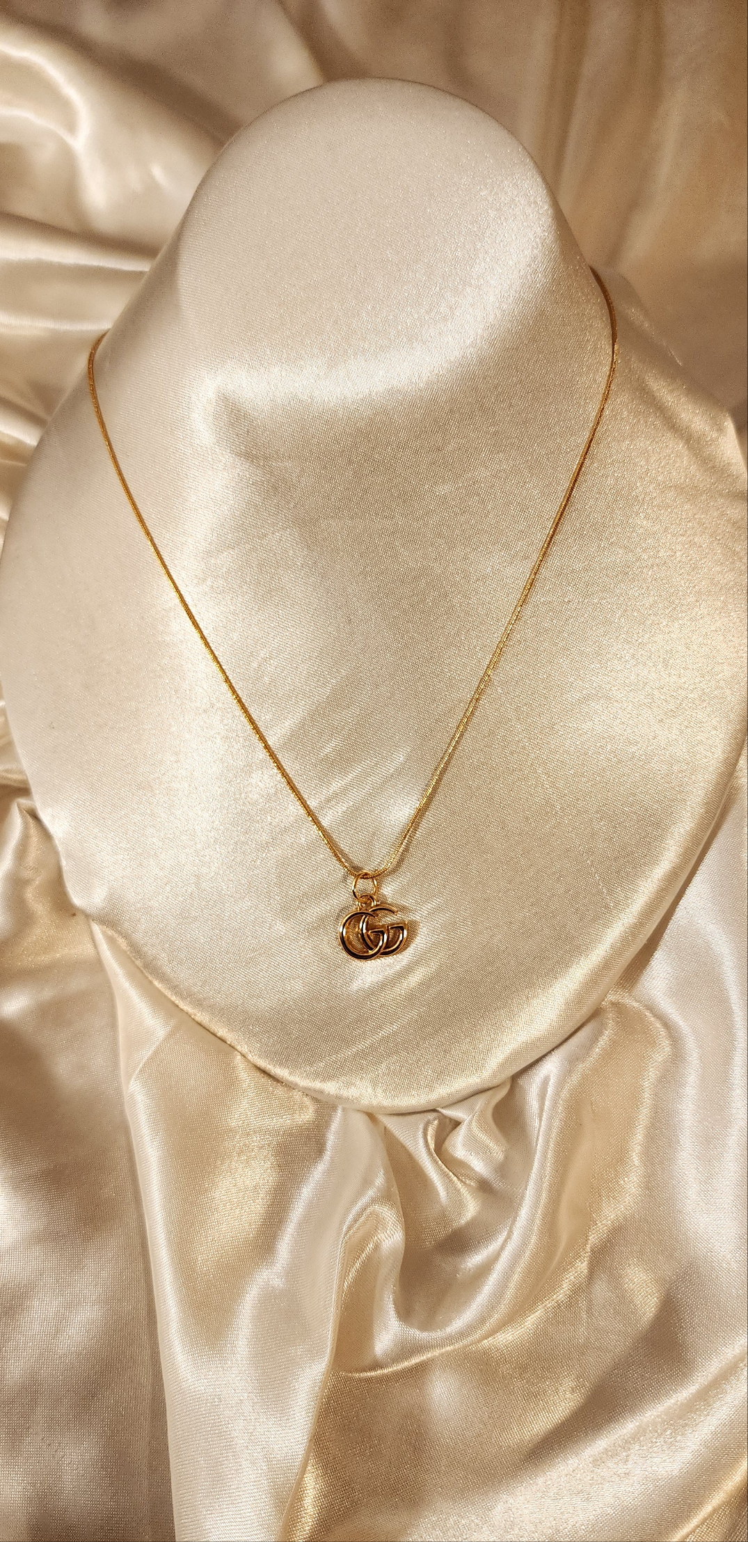 Repurposed vintage charm necklace from GG Era Collection with a mini gold-tone pendant and a solid sterling silver chain plated in gold vermeil.