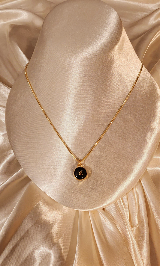 Repurposed vintage charm necklace from LV Era Collection with black and gold detail pendant and a solid sterling silver chain plated in gold vermeil.