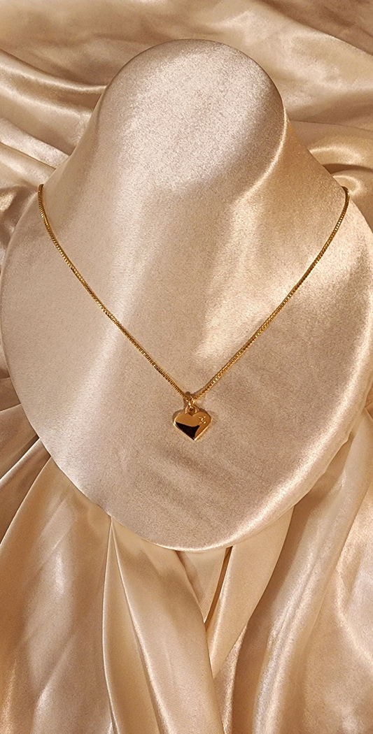 Repurposed vintage charm necklace from LV Era Collection with a gold-tone heart pendant and a solid sterling silver chain plated in gold vermeil.