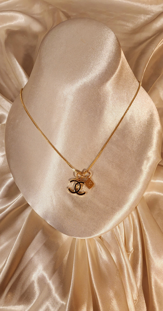 Repurposed vintage charm necklace from CC Era Collection with a gold-tone keychain pendant and a solid sterling silver chain plated in gold vermeil.