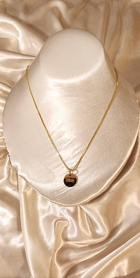 Repurposed vintage charm necklace from DR Era Collection with a delicate gold-tone pendant and a solid sterling silver chain plated in gold vermeil.