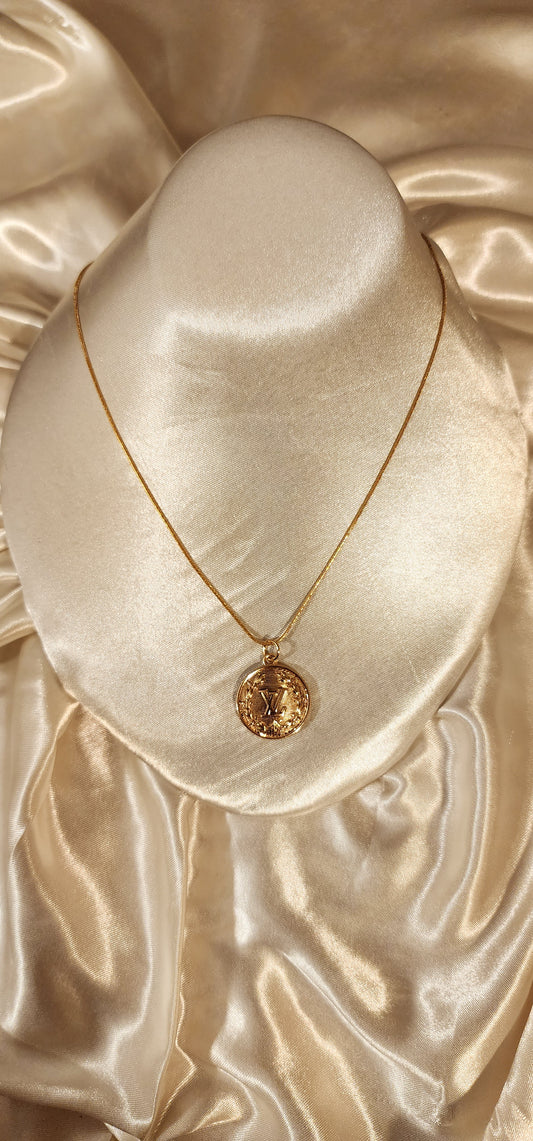 Repurposed vintage charm necklace from LV Era Collection with a round gold pendant and a solid sterling silver chain plated in gold vermeil.
