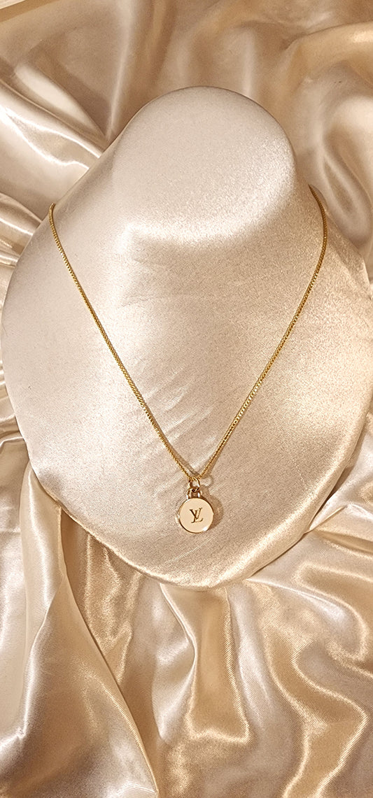 Repurposed vintage charm necklace from LV Era Collection white charm pendant and a solid sterling silver chain plated in gold vermeil.