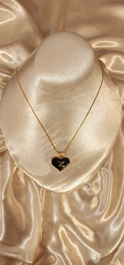 Repurposed vintage charm necklace from LV Era Collection with a black heart pendant and a solid sterling silver chain plated in gold vermeil.
